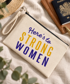 Natural canvas wristlet pouch with Here’s to Strong Women lettering in purple and yellow