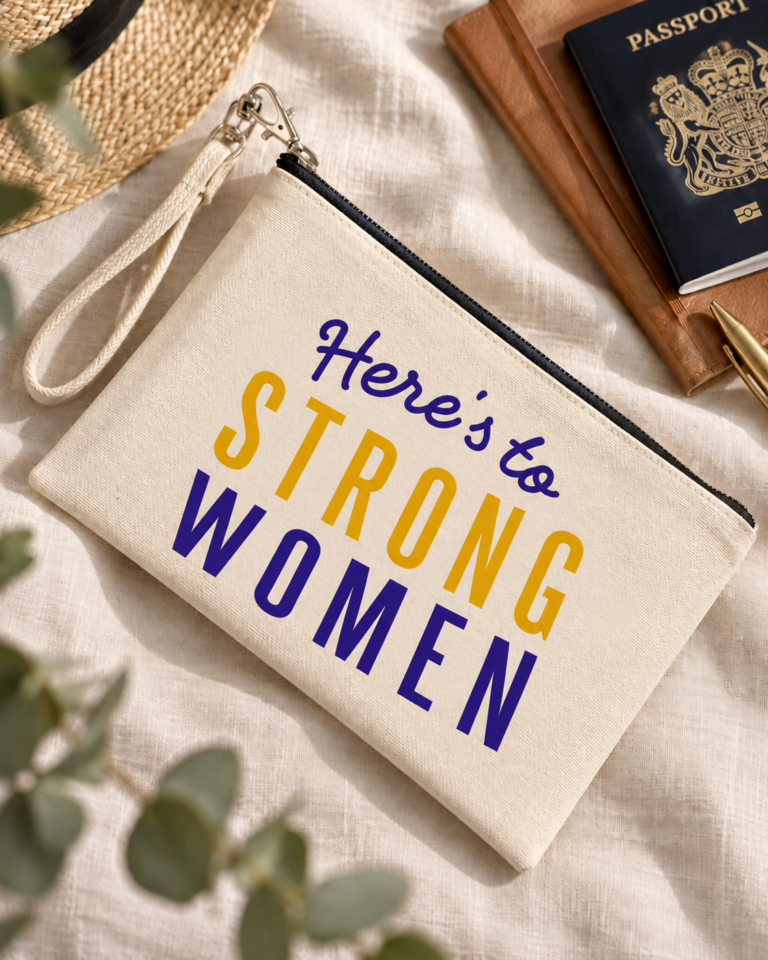Natural canvas wristlet pouch with Here’s to Strong Women lettering in purple and yellow